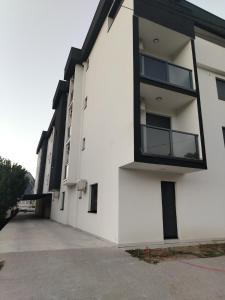 a white building with a lot of windows at Duša apartman in Banja Koviljača