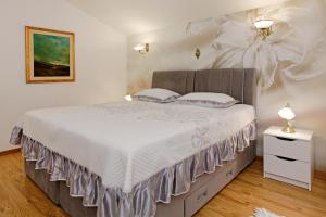 a bedroom with a bed with a flower wall at Villa Goga in Vela Luka +52 photos