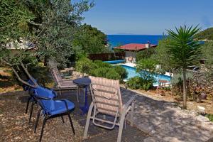 a patio with chairs and a table next to a pool at Villa Goga in Vela Luka