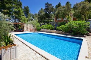 a swimming pool in a yard with a house at Villa Goga in Vela Luka