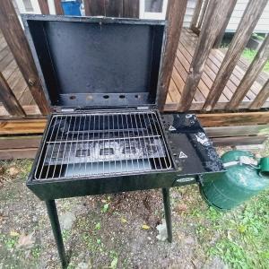 a grill sitting on the ground with a green pot at AirCon Deluxe Mobilhome near Europapark in Boofzheim +7 photos
