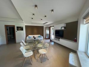 a living room with a glass table and a couch at Villa Anzio in Anzio