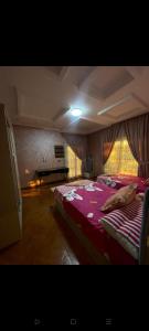 a large bedroom with a large bed with a pink blanket at رويل هيلز in 6th Of October +14 photos