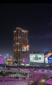 a tall building at night with traffic in a city at Hostal oasis in Cairo