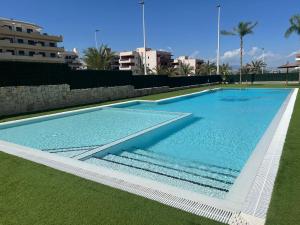 a large swimming pool with blue water at Claudia Luxury in Arenales del Sol
