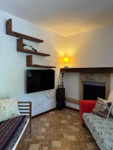 a living room with a flat screen tv and a couch at Villa hira in Eski Datca