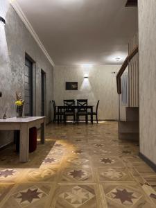 a living room with a table and chairs and a tile floor at Madoyans Rest House in Antarut