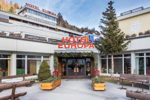 a large building with a sign on the side of it at Hotel Europa St. Moritz in St. Moritz