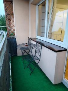 a table and chairs on the balcony of a house at Apartament Julia in Zamość