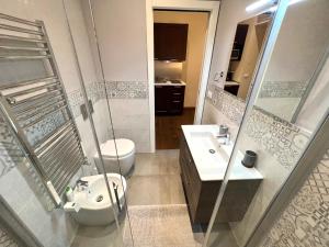 a bathroom with a toilet and a sink at Italy Vacation Rental in Trieste +9 photos