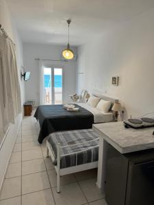 a bedroom with two beds and a table in it at Christina's House in Koufonisia