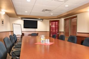 a conference room with a large wooden table and chairs at Days Inn by Wyndham Thunder Bay North in Thunder Bay