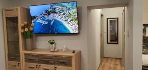 a living room with a flat screen tv on a wall at APARTAMENT MAJA - centrum, parking in Kudowa-Zdrój