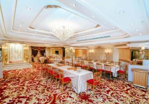 a banquet hall with tables and chairs and a chandelier at فندق دار الريس - Dar Raies Hotel in Makkah +16 photos