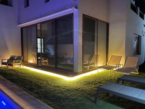 a patio with chairs and lights in front of a building at Villa Tama Luxury & Relax in Costa Teguise