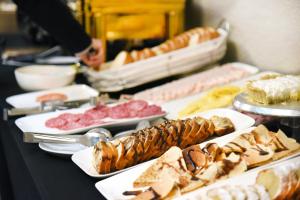 a buffet line with different types of food on plates at Hotel HW EXPRESS in Santiago