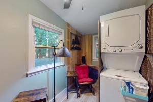 a kitchen with a refrigerator and a red chair at View for Two in Ellijay