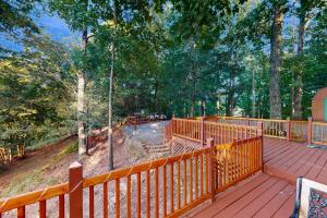 a deck with a wooden fence and trees at View for Two in Ellijay