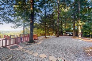 a driveway with a fence and a car parked in the woods at View for Two in Ellijay