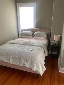 a bed in a bedroom with a window at Victorian Getaway in Cincinnati