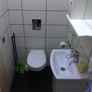 a bathroom with a white sink and a toilet at Apartment Ekaterininskaya 5 in Simferopol