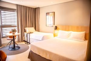 Cozzy Suites Paraíso Hotel客房内的一张或多张床位
