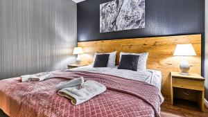 Łóżko lub łóżka w pokoju w obiekcie Apartament SPA 44 Resort Kozubnik blisko Szczyrk- 5D Apartamenty