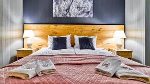 Łóżko lub łóżka w pokoju w obiekcie Apartament SPA 44 Resort Kozubnik blisko Szczyrk- 5D Apartamenty