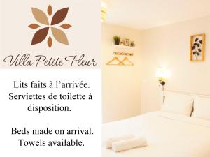 a bedroom with a white bed with a plant on the wall at Villa Petite Fleur proche Paris CDG Disney Astérix et Parc des Expos in Villeparisis +25 photos