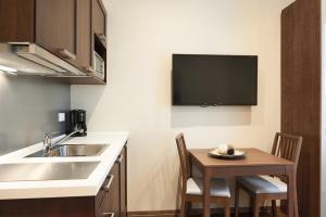 a kitchen with a sink and a table with chairs at Italy Vacation Rental in Trieste