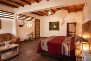 une chambre avec un lit et un canapé dans l'établissement Hotel boutique Teocalli, à Tepoztlán