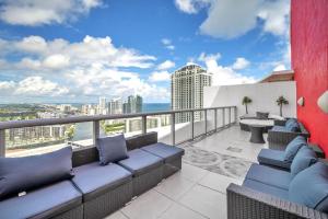 a balcony with furniture and a view of the city at Penthouse Sky Suite - 2BDR2BTH - Private Rooftop Terrace in Hallandale Beach