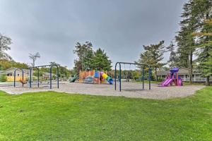 a playground with slides and play equipment in a park at Pet Friendly! Lakefront w Hot Tub, Firepit! in Tobyhanna