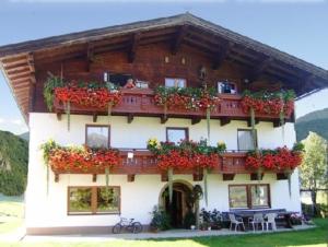 un edificio con cajas de flores en la parte delantera en Hinterankerwald, en Walchsee