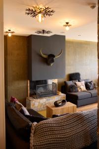 a living room with a couch and a fireplace at Hôtel Le Grand Tétras in Font-Romeu
