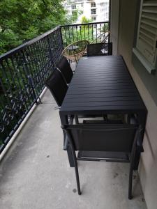a black picnic table sitting on a balcony at Côté DÔMES in Saint-Gervais-les-Bains +7 photos