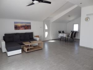 a living room with a couch and a table at Tuan Vir Apartment in Vir