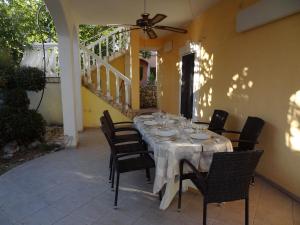 a table set up for a meal on a patio at Tuan Vir Apartment in Vir