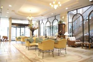 a lobby of a hotel with chairs and a table at Hotel Rose Garden Shinjuku in Tokyo