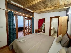a bedroom with a large bed and a large window at Jua Zuri in Lushoto