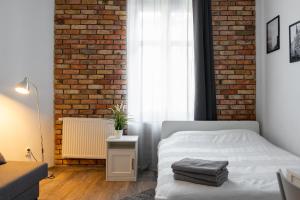 Łóżko lub łóżka w pokoju w obiekcie Stay99 Apart