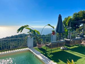 a backyard with a swimming pool and an umbrella at SeaHomes Vacations, LA CASA BLUE Mediterranean Lifestyle in Blanes