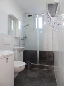 a bathroom with a shower and a toilet and a sink at Tuan Vir Apartment in Vir +57 photos