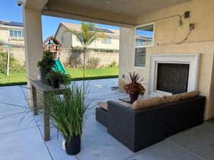 a patio with a couch and a fireplace at This listing is not availabl in Eastvale