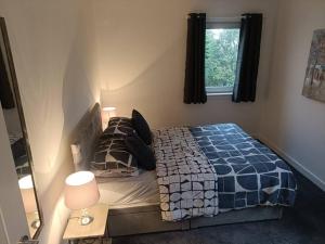 洛哈尔什教区凯尔高地2 bed highland home base for Isle of Skye and Lochalsh的一间卧室设有一张床、一个窗口和一面镜子