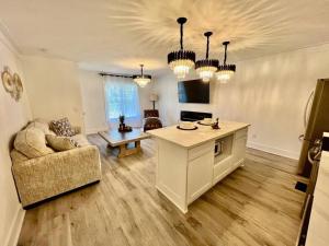 a living room with a couch and a table at Luxury City Loft in Gainesville D in Gainesville