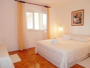 Postel nebo postele na pokoji v ubytování Apartments Nedjeljka