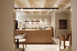 a kitchen with a counter with a table and chairs at San Karlu in Valletta