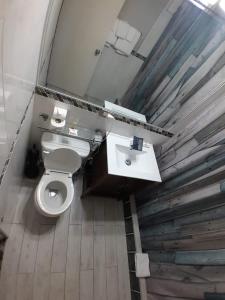a bathroom with a white toilet and a sink at Contemporary One Bedroom at Sandcastles in Ocho Rios