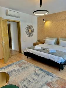 a bedroom with a large bed and a rug at Blancris Boutique in Braşov